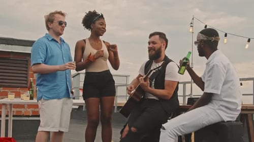 Group of Friends Having Party on Rooftop Terrace