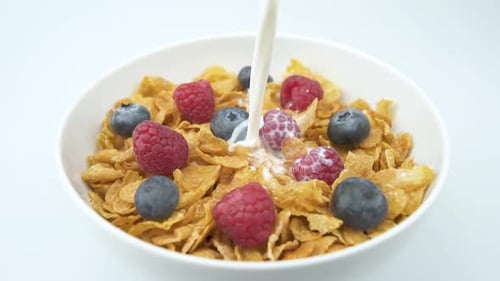 Milk Pouring into Cereal with Berries