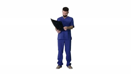 Man in Scrubs Examines Medical Scan