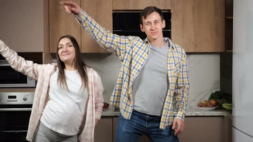 Smiling Couple Dancing in their Home Kitchen