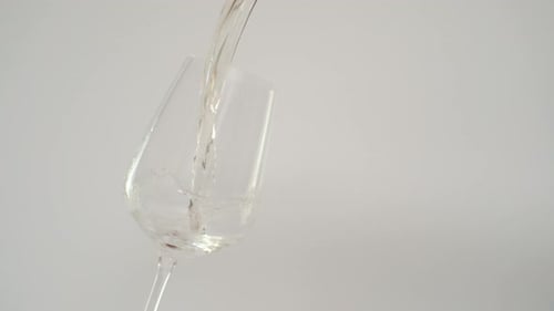 White Wine Pouring into Glass in Slow Motion