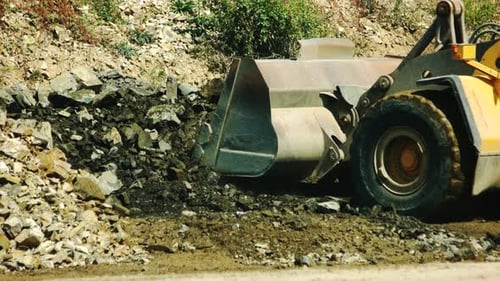 Excavator Loading Granite Stones in the Quarry