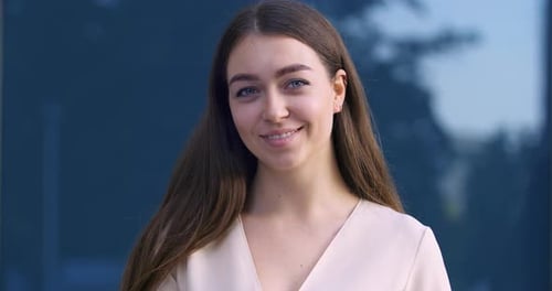 Beautiful Young Woman Smiling Confidently at Camera
