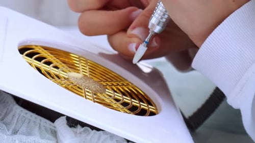 Woman Using Electric File for Manicure, Close-Up