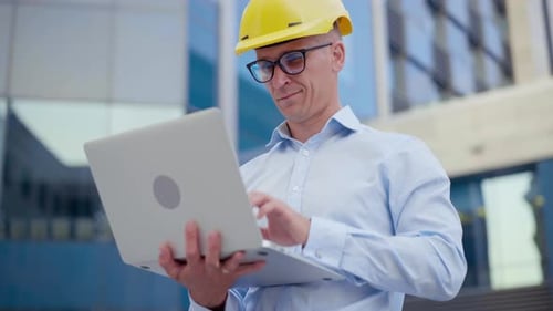 Business Architect Using Laptop Outdoors Office Building Background