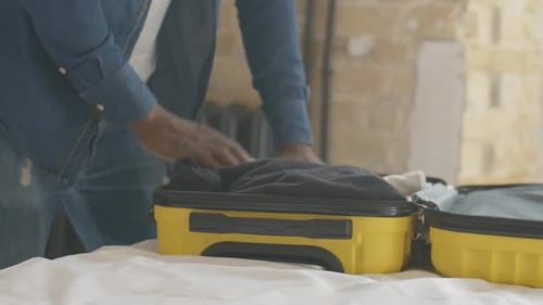 Adult Packing Yellow Suitcase For Travel