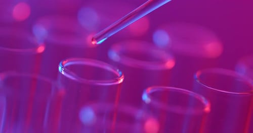 Liquid Being Dripped Into Test Tubes in Lab