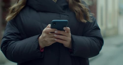 Close Up Woman Typing By Mobile Phone Outdoors. Closeup Cheerful Girl with Smartphone in Old City