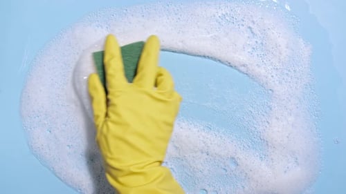 Hand in Glove Cleans Soapy Blue Surface