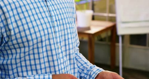 Focused Man Using Tablet in Modern Office