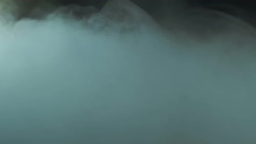 Dreamy Blue Smoke Floating Slowly in Dark Space