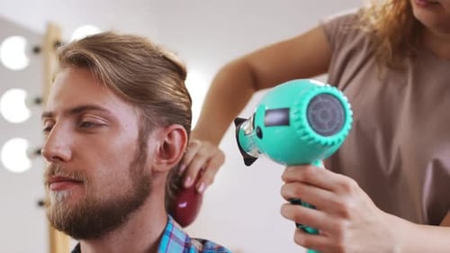 Stylish Man Gets Hair Styled with Brush and Dryer