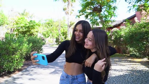 Two Young Women Pose for Tropical Selfie