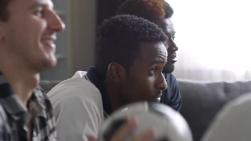 Friends Cheering During Exciting Soccer Match At Home