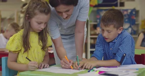 Creative Kids During an Art Class in a Daycare Center or Elementary School Classroom Drawing with