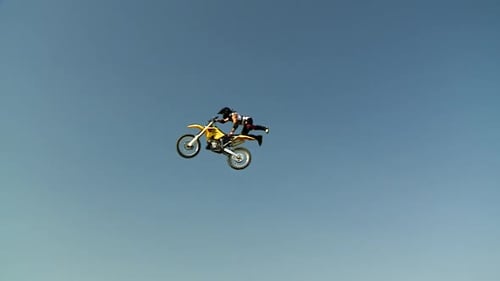 Man Performing Motocross Stunt Against Blue Sky