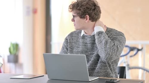 Adult Rubbing Neck While Working at Computer