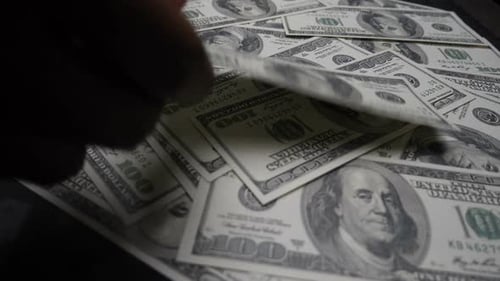 dollars bills falling on the pile banknotes