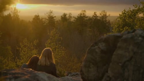 Two Girlfriends Are Looking on the Sunset