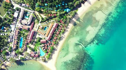 Summer holiday resorts on shore of tropical island with white sandy beaches washed by turquoise lago