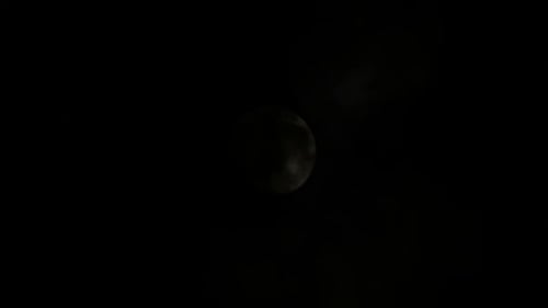 Clouds Drift Across the Moon at Night
