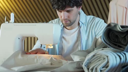 Tailor Working on a Sewing Machine at the Sewing Workshop