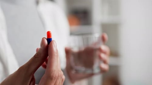 Close Up Hand Fingers Hold A Bright Pill In The Form Of A Capsule Female Fingers Held A Pill Capsule