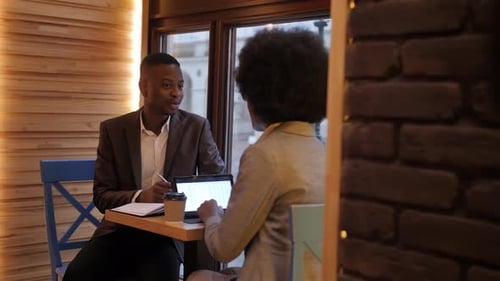 African Colleagues Discussing Working Issues at Cafe
