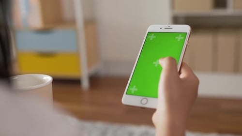 Closeup of hand woman using smartphone with green screen