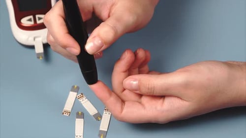 Self-testing for Diabetes. Woman Using Lancet and Glucomete