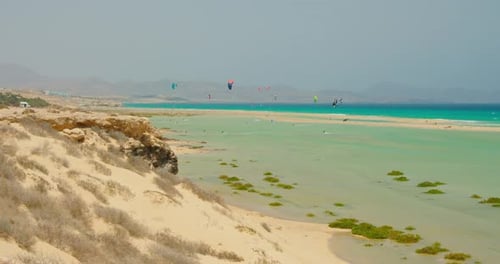 Group of Unrecognizable Paragliders Fly Over Golden Sand Beach Sea Landscape at Sunny Summer Day