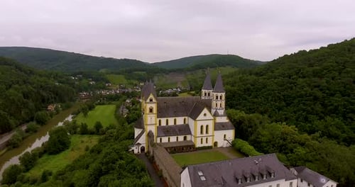 Drone Flight above German Monastery. View on river and village.