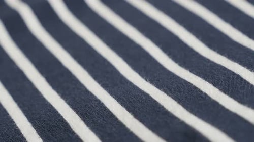 Blue and white striped fabric sample close-up 4K 2160p 30fps UltraHD footage - Panning over sailor m