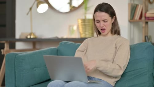 Woman Using Laptop Massaging Her Wrist in Pain