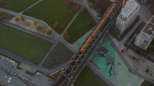 Iconic Typical Berlin Subway Train Yellow Color Passing Bridge Through Public Park Germany Aerial