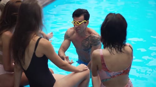 Young Adults Relaxing by a Pool on Sunny Day