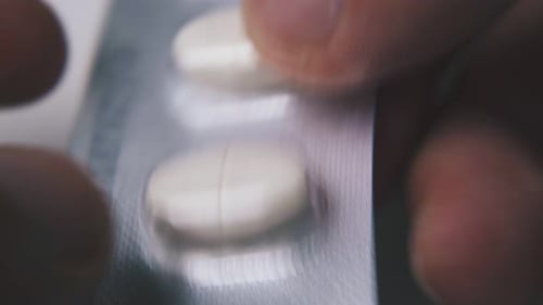 Close Up Removing Pill from Blister Pack