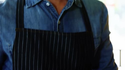 Smiling Barista Holding Cup of Coffee Close Up
