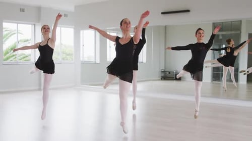 Women Practice Ballet in Bright, Modern Studio