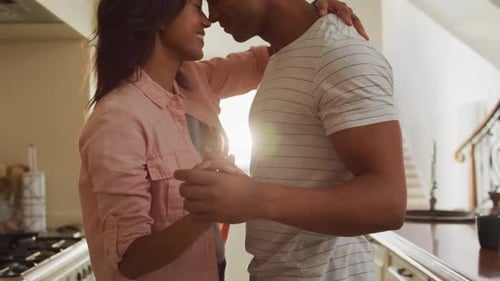 Romantic Couple Embracing in Kitchen