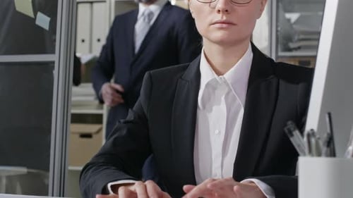 Female Office Worker Typing on Wireless Keyboard at Desk