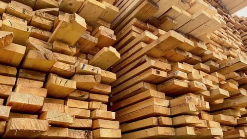 Stacked Lumber with Blue Sky and Clouds