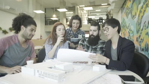 Colleagues looking at blueprint together