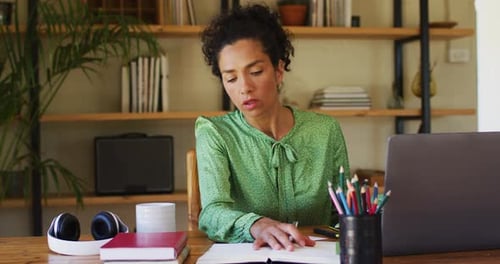 Woman Working from Home Writing in Journal