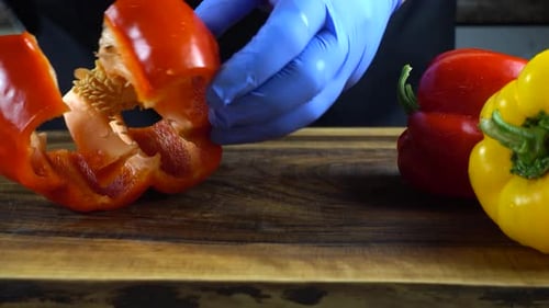 Preparing Peppers, Gloved Hands on a Cutting Board