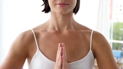 Woman Meditating Peacefully with Hands in Prayer Position