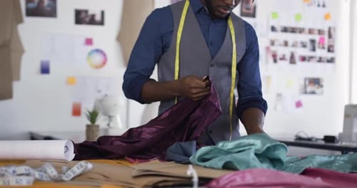 Mixed race man working in fashion office