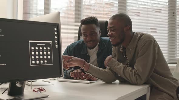 African-American Programmers Discussing Program on PC, Technology Stock ...