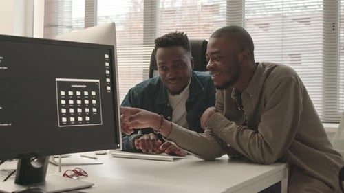 African-American Programmers Discussing Program on PC