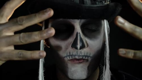 Person With Skeleton Face Paint and a Hat